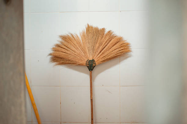 Floor broom is located in the bathroom, for cleaning.