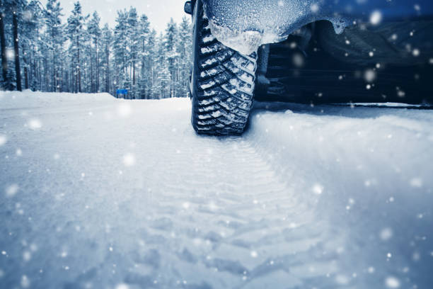 istock Car tires on winter road covered with snow 1048063694