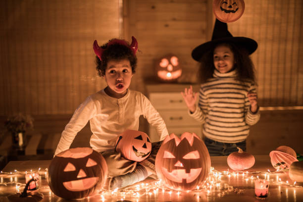 istock Two black siblings having fun on Halloween at home. 1048065516