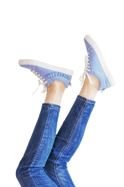 istock Woman legs in a blue jeans on white background isolated 1048065894
