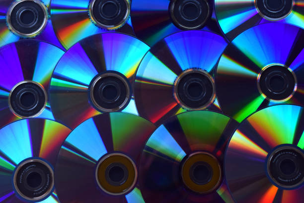 istock Background of illuminated DVD discs and CDs. 1048070282