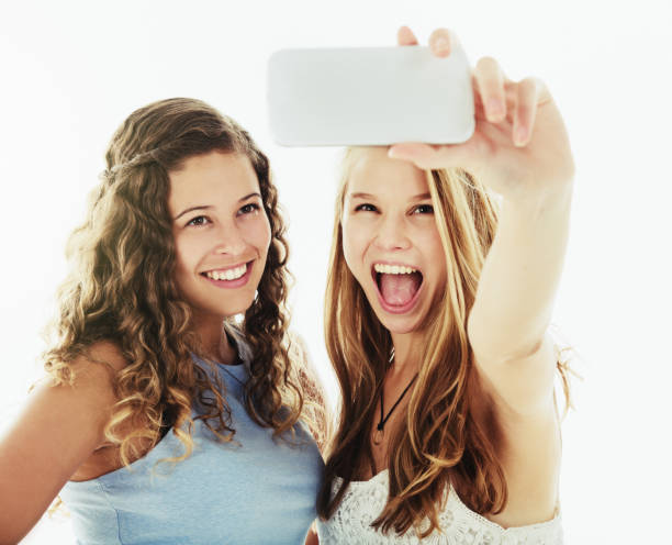 istock Pretty girlfriends take a laughing selfie 1048074270