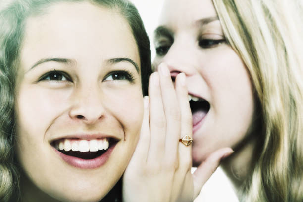 istock Scandalous secrets being passed from one pretty girl to another 1048075226