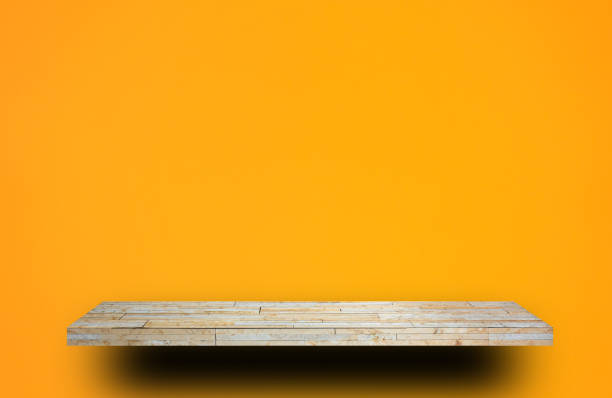 istock Cream Rock counter shelf on orange wall background 1048077702