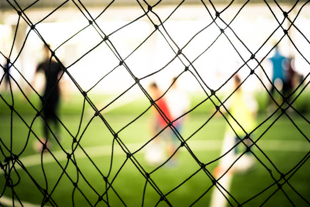 istock Soccer training net blur on training ground with children 1048077852