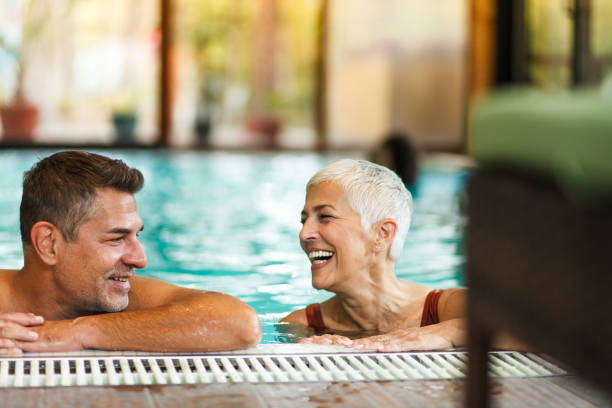 istock Mature couple having fun at the swimming pool 1048078476