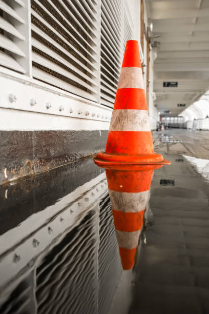 istock Traffic pylon reflected in a pool of water 1048084516