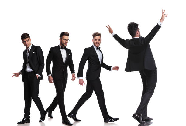 istock four elegant men in tuxedoes walking in different directions 1048084572