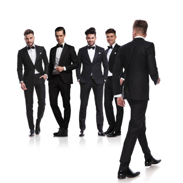 istock five men dressed in tuxedoes with leader walking back 1048087178