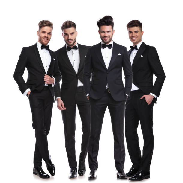 istock four elegant young men in tuxedos standing together 1048087280