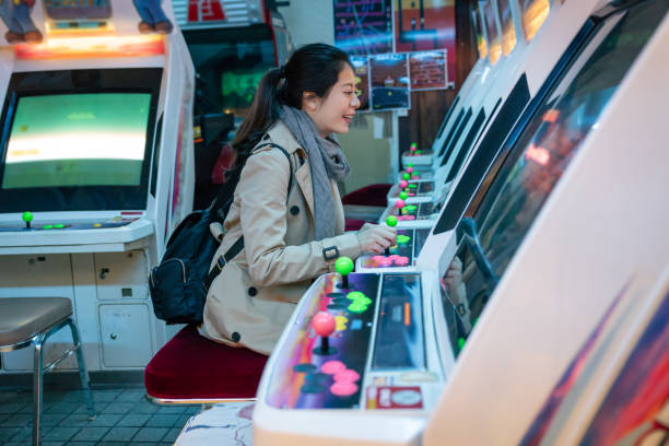 cheerful woman sitting in front of the game machine and happily playing game like a little girl