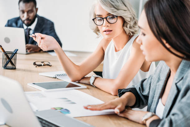 istock multiethnic businesswomen talking about project in office 1048094608