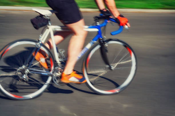 istock Racing bicycle in blurred motion speeding down the road. 1048097294