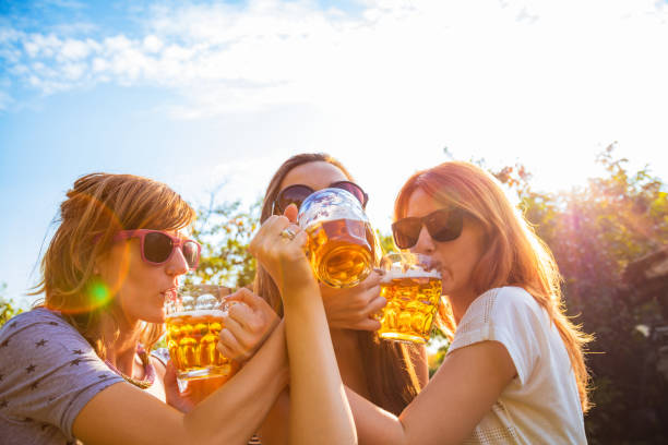istock Group of young women enjoying outdoors with beer. 1048097414