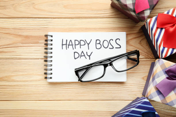 istock Inscription Happy Boss Day in notebook with gift boxes and glasses 1048097760