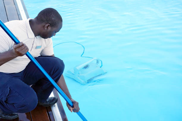istock Hotel staff worker cleaning the pool 1048098028