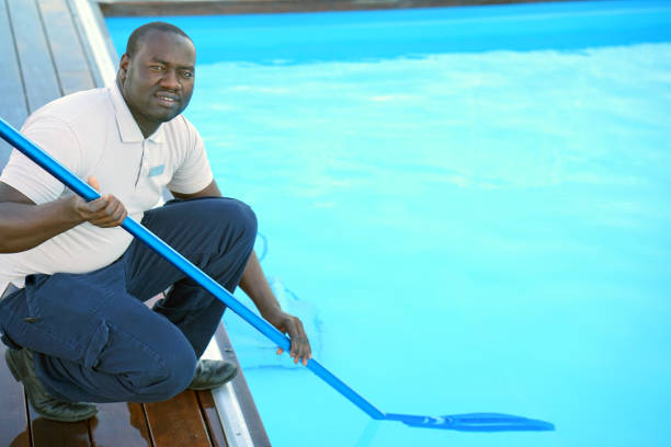istock Hotel staff worker cleaning the pool 1048098700