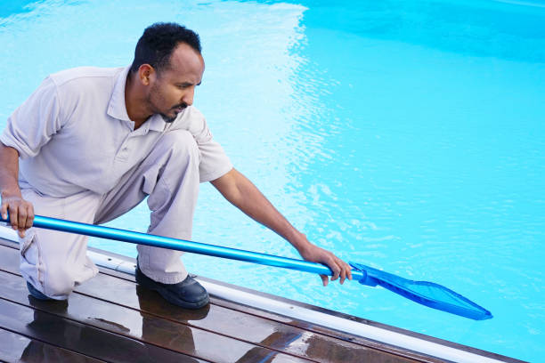 istock Hotel staff worker cleaning the pool 1048098962