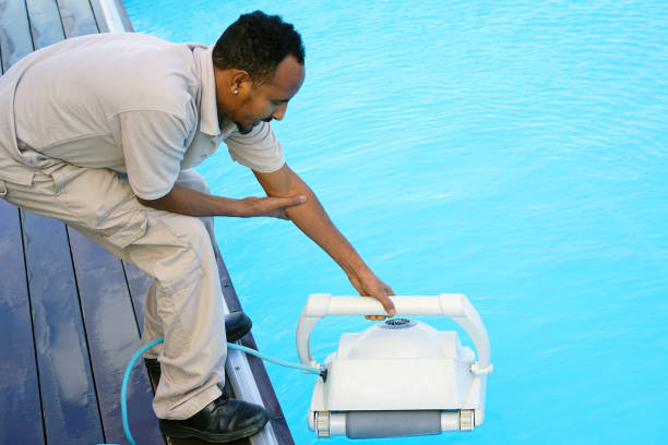 istock Hotel staff worker cleaning the pool 1048099076