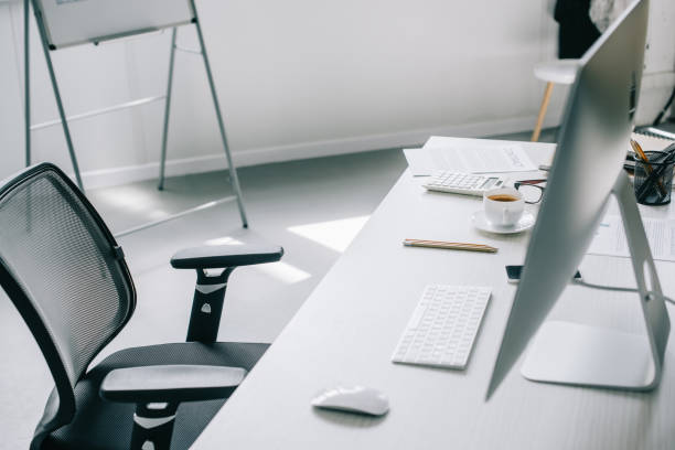 istock computer, table and chair in light modern office 1048099386