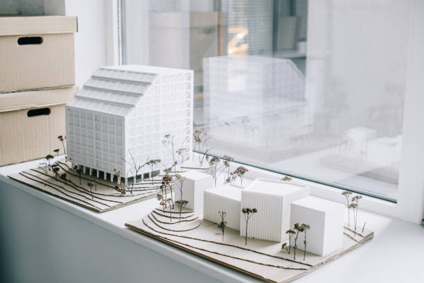 white architecture models on windowsill in light modern office white architecture models on windowsill in light modern office architectural model photos stock pictures, royalty-free photos & images