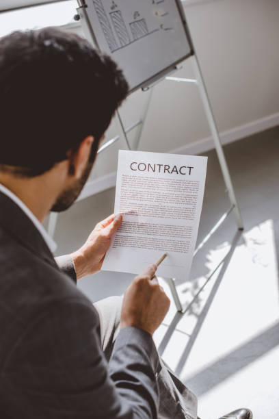 istock high angle view of businessman reading contract in office 1048102542