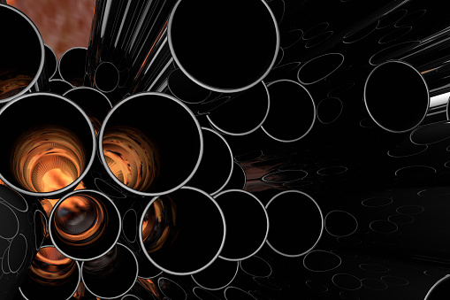 Stack of shiny metal steel pipes with flame