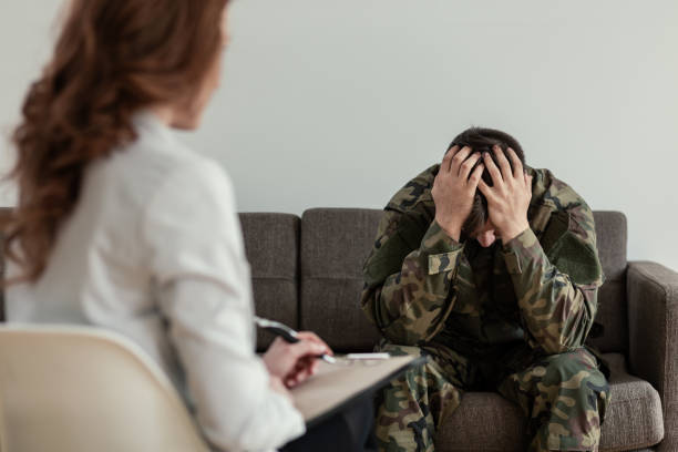 istock Unhappy soldier with depression and emotional problem during therapy with psychotherapist 1048105042