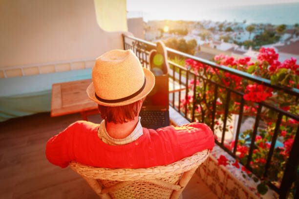istock remote work concept- young man with laptop on scenic terrace 1048105812