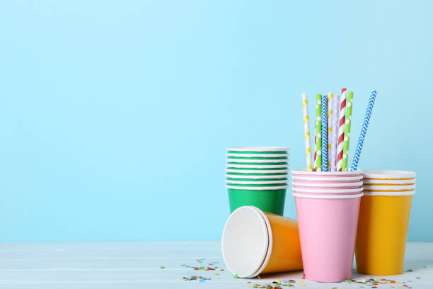 istock Colorful paper cups with straws on blue background 1048105822