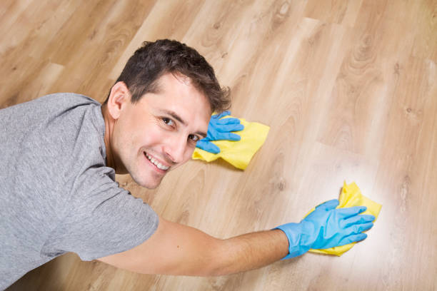 istock Ready to clean up. Smiling young husband cleaning floor at home 1048108000