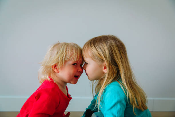 istock happy cute little sisters play at home 1048108508