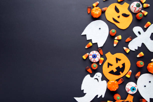 istock Halloween candies with decorations on black background 1048109122