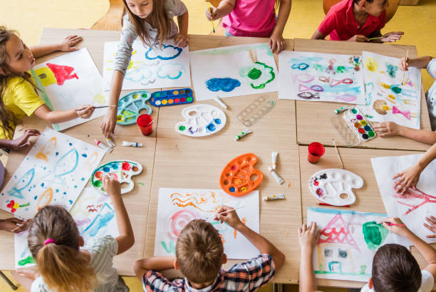 istock Above view of large group of elementary students having an art class in the classroom. 1048109782