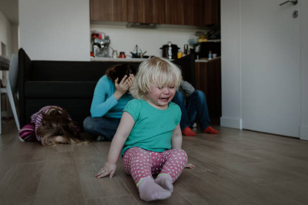 istock difficult parenting- crying kids and tired mother 1048110822