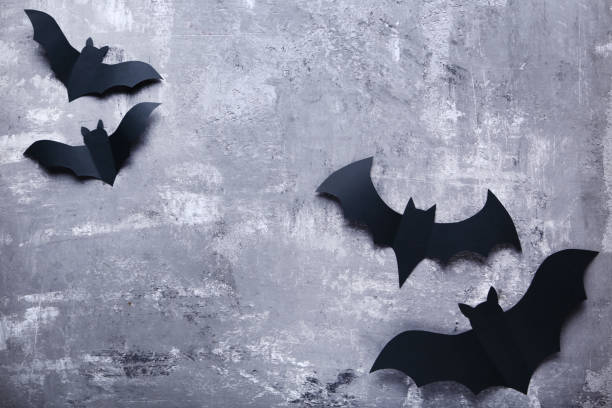 istock Halloween paper bats on gray background 1048113248