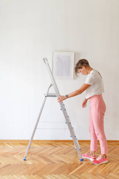 istock Woman standing by the ladder 1048113724