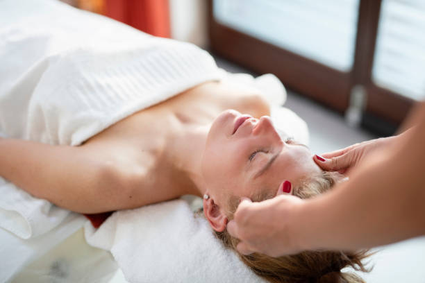 istock Woman enjoying a head massage at a beauty spa 1048115452