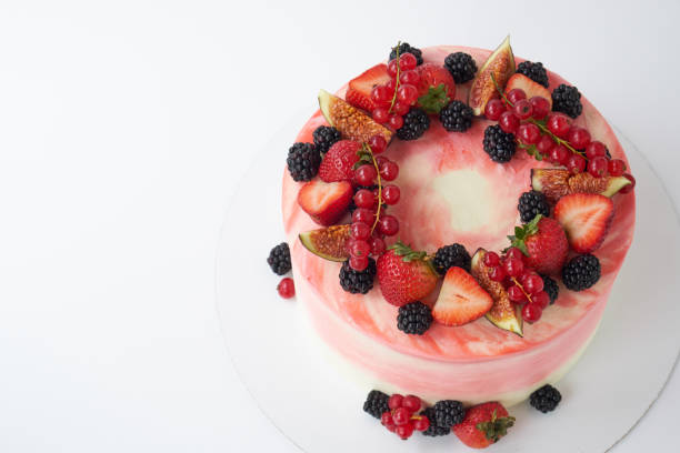 istock Cake with whipped pink cream, decorated with fresh strawberries, blackberry, figs and red currant. 1048119896