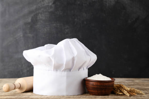 istock Chef hat with flour and rolling pin on wooden table 1048120604