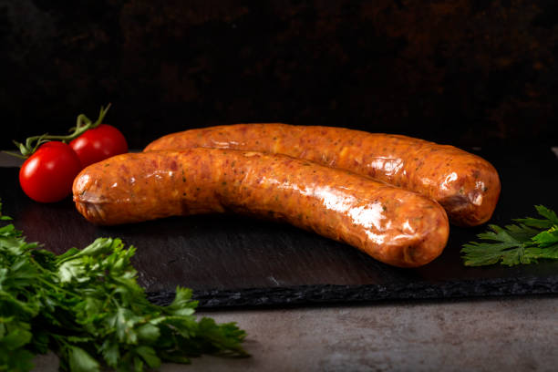 istock Two smoked pork sausages with herbs and sherry tomatoes 1048121532