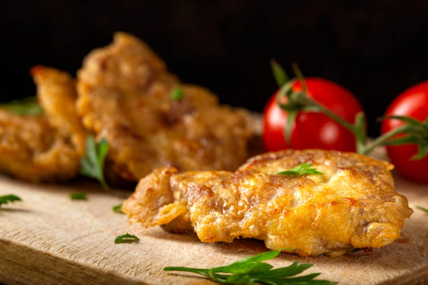istock Schnitzel made from pork brain, flour and eggs on a wooden cutting board 1048121636