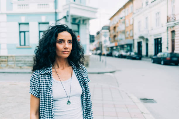 istock Pensive woman standing on street 1048136640