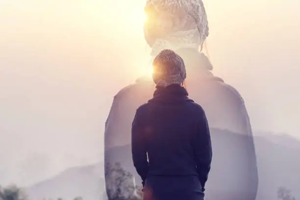 Photo of Double exposure, Woman in mountains with sunrise and sunlight effect, Rear view