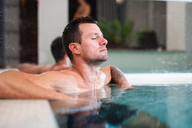 istock Man relaxing in a swimming pool at a spa 1048142218