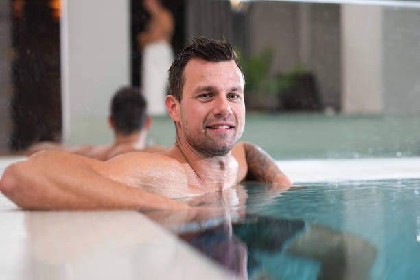 istock Man relaxing in a swimming pool at a spa 1048142226