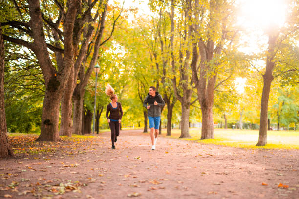 istock Happy young couple running outdoor. 1048143382