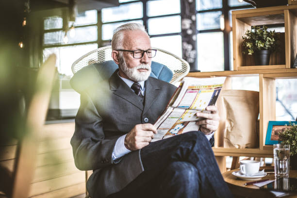 istock Time for relax. Senior businessman riding newspaper. 1048143676