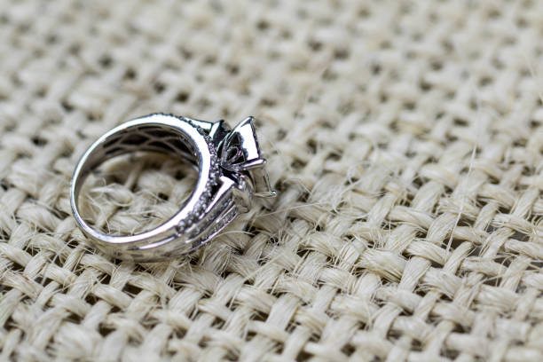 istock A diamond engagement ring in a box with glint/reflection. Shimmering princess-cut diamonds. 1048146822