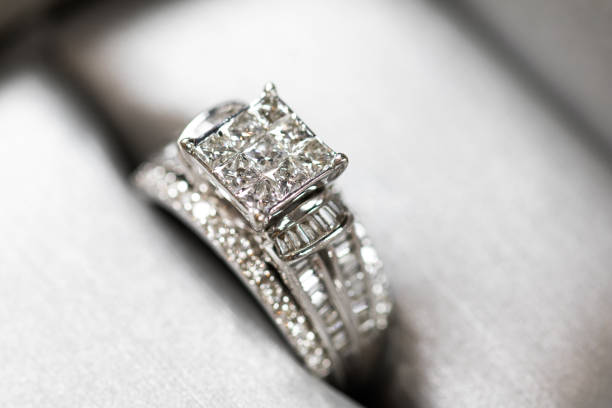 istock A diamond engagement ring in a box with glint/reflection. Shimmering princess-cut diamonds. 1048147080